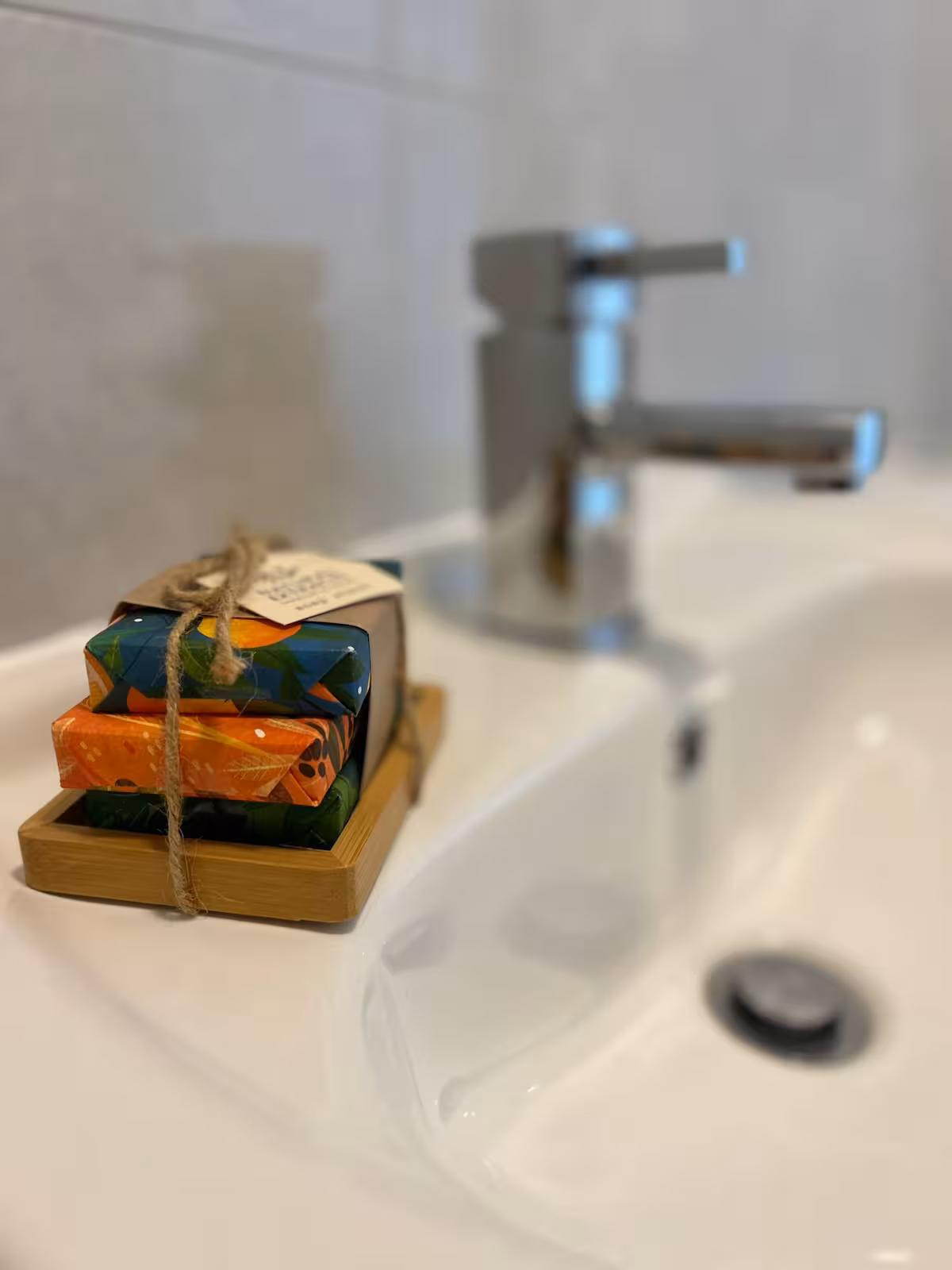 White, semi-circular sink with toiletries