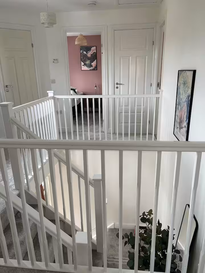 Staircase and landing with pretty, white bannister